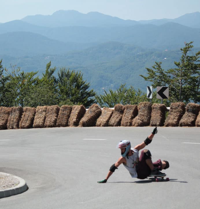 Coleman Slides on a longboard